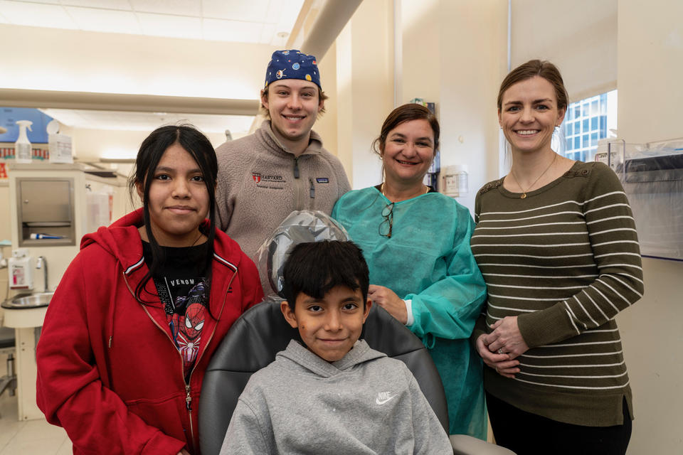 Two dentists with three patients in a dental clinic