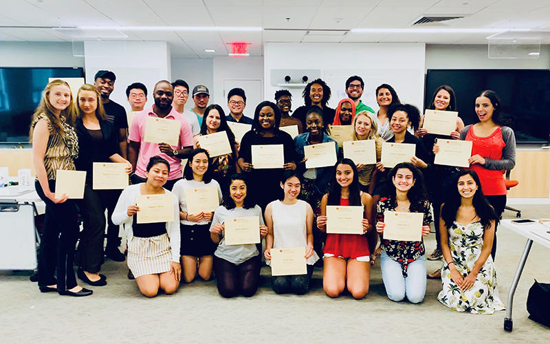 Participants in last year's Bridge to Dental School program pose with their certificates and HSDM mentors.