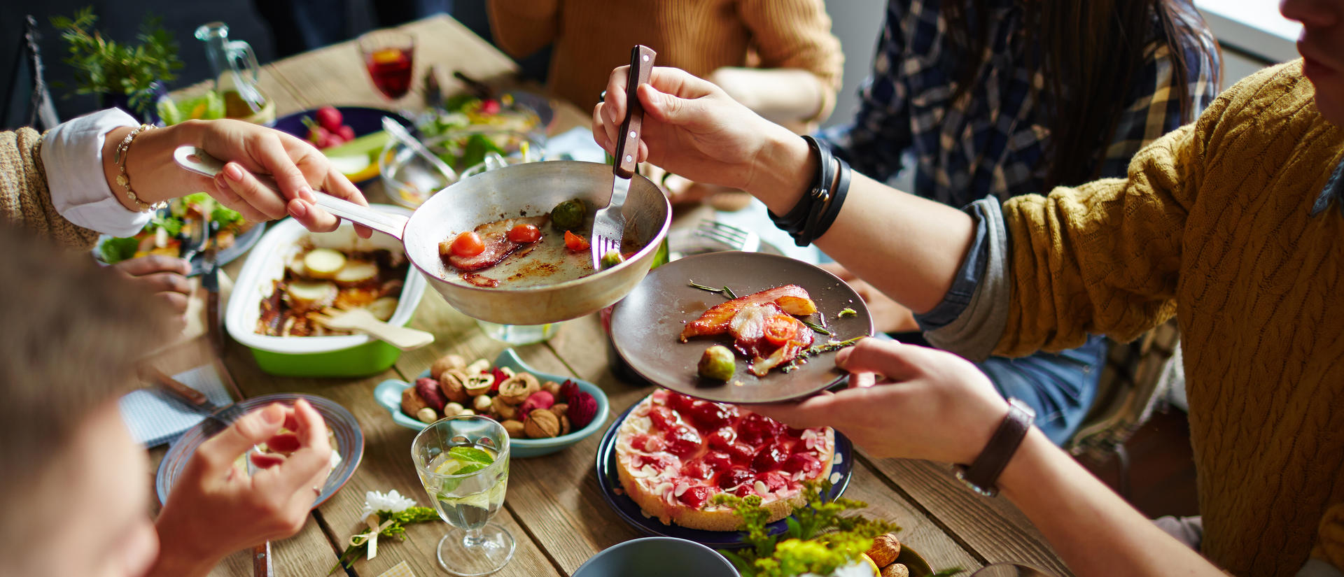 People gathered around a table serving food