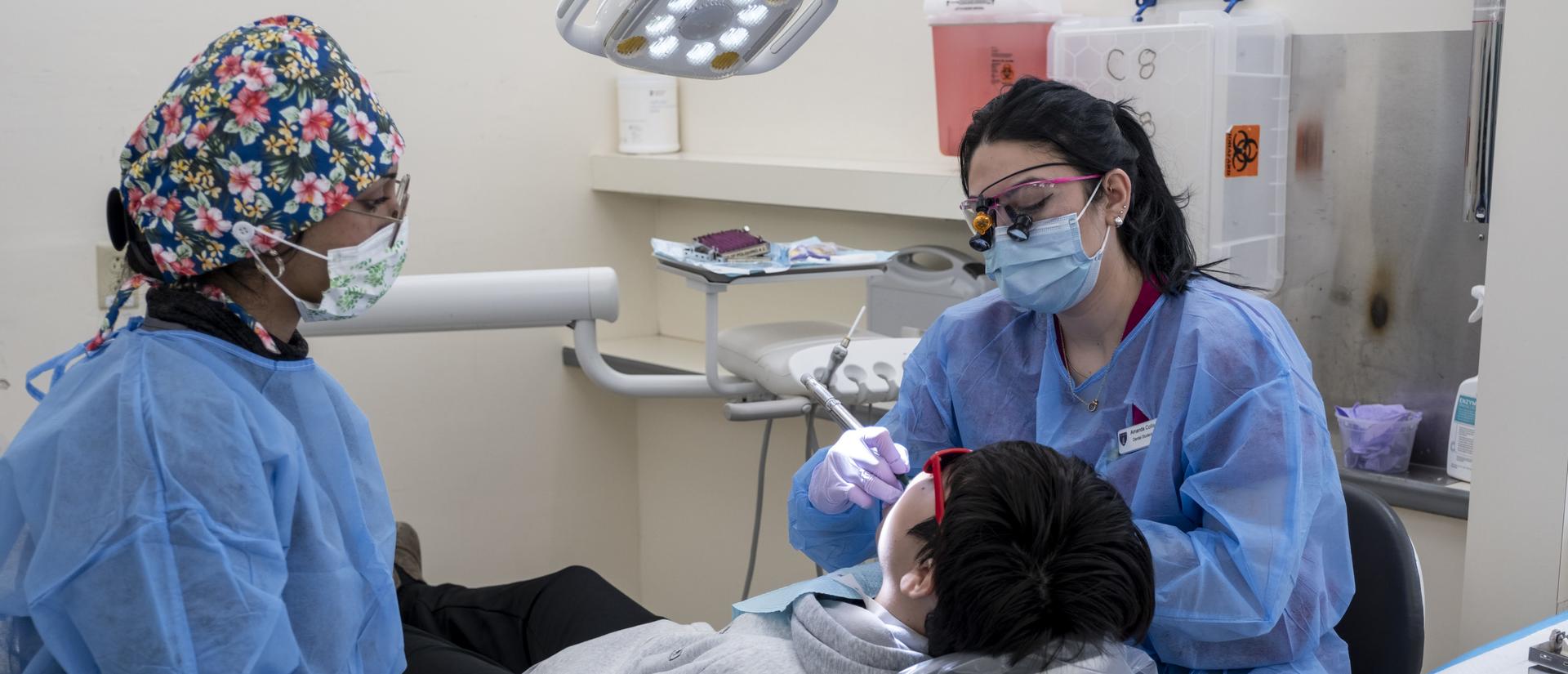 A dentist working with a patient in the clinic