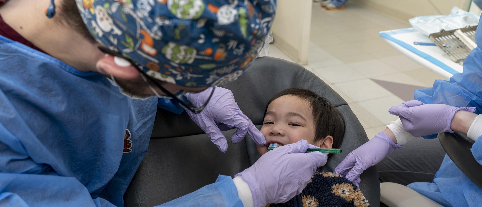 A dentist working with a patient in the clinic