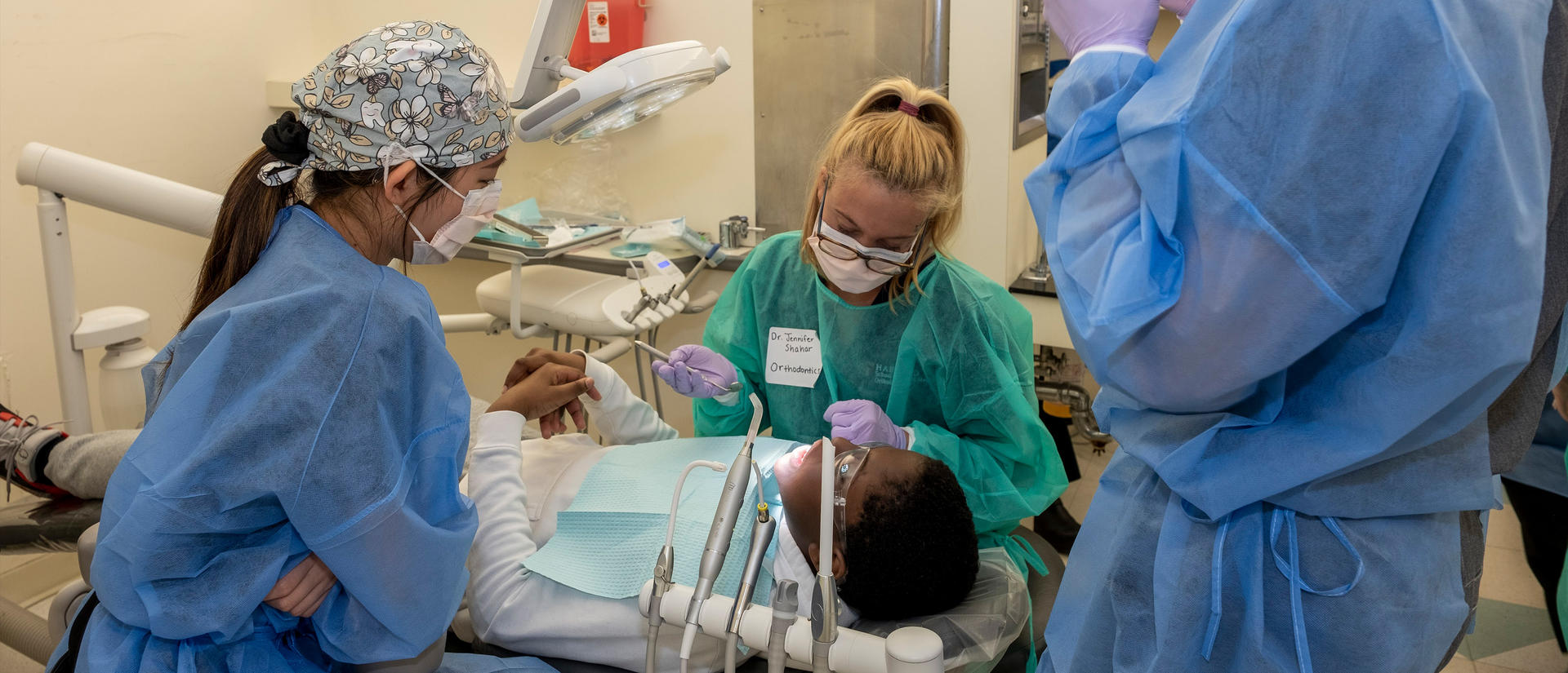 students working on a patient in the clinic