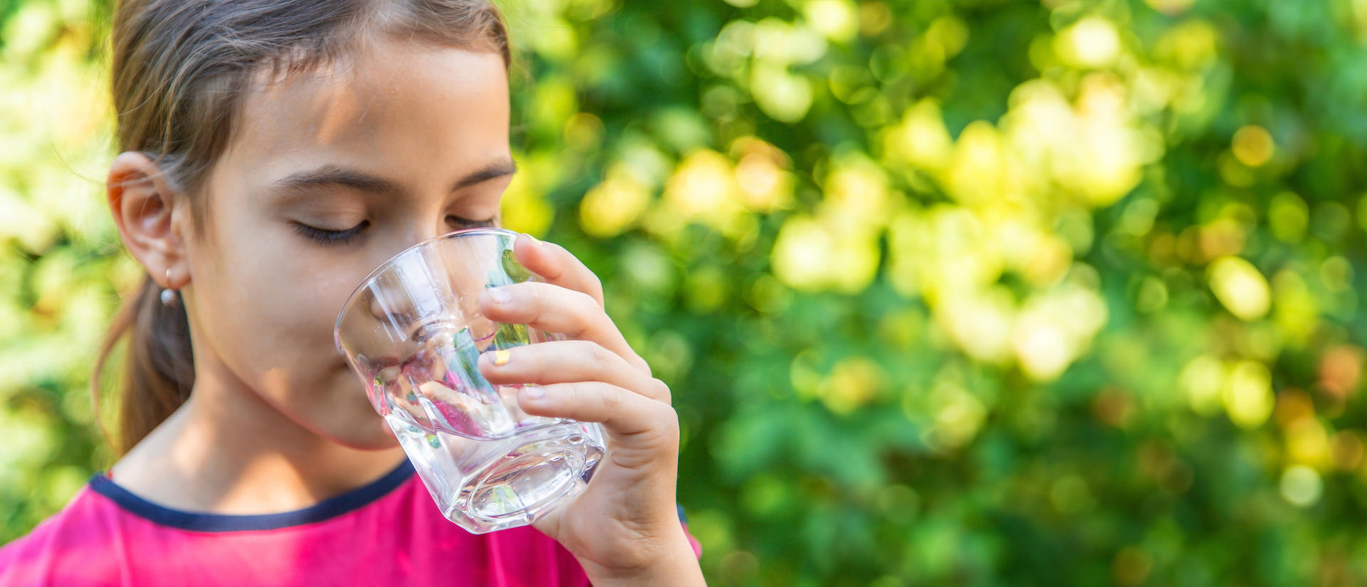 girl drinking a glass of water