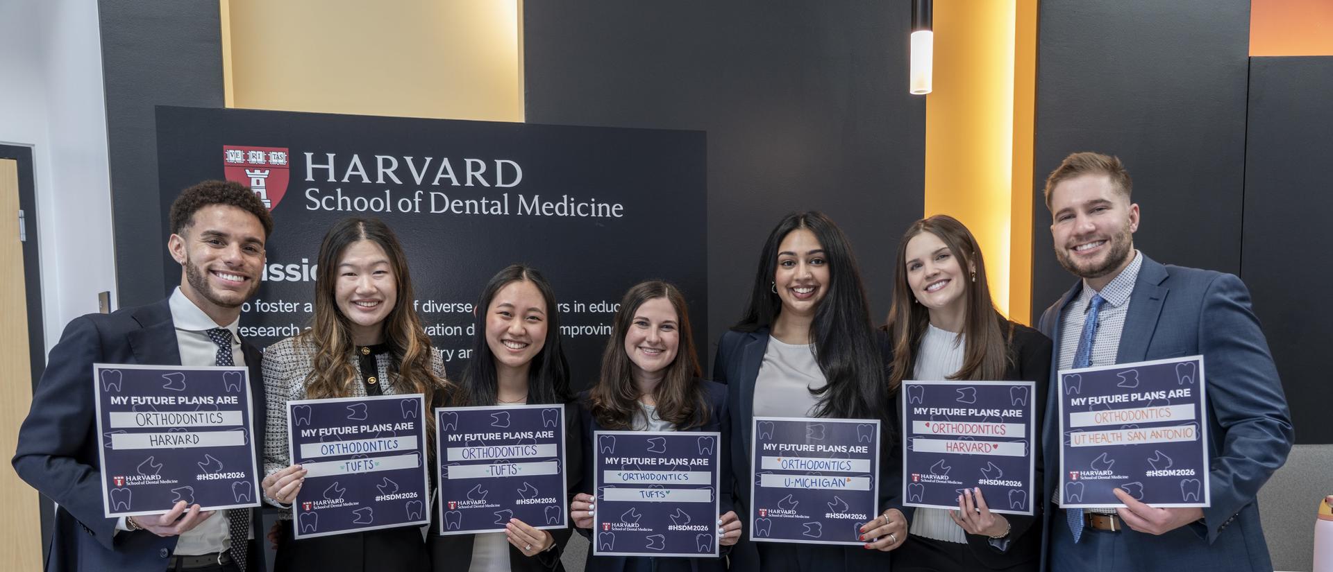 Students holding signs with listing their match programs