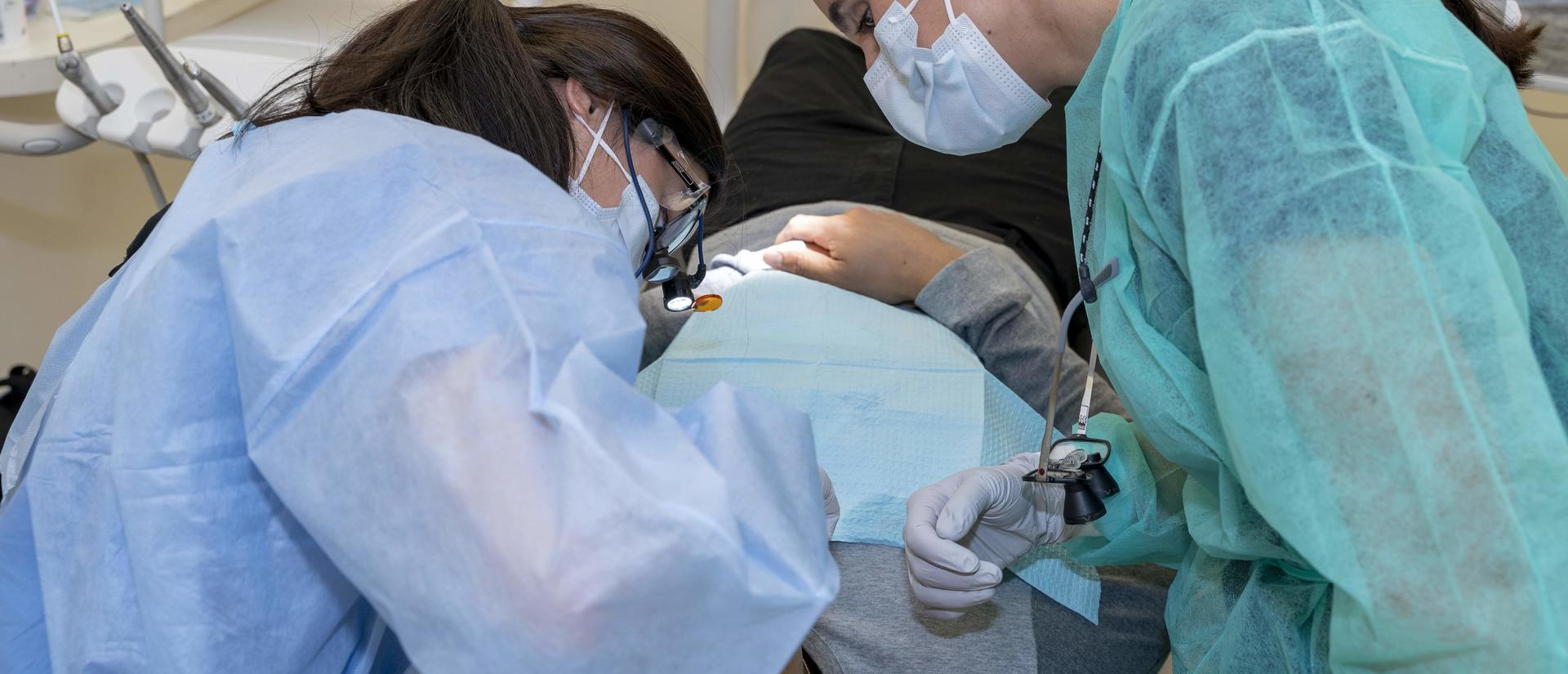 students working on a patient