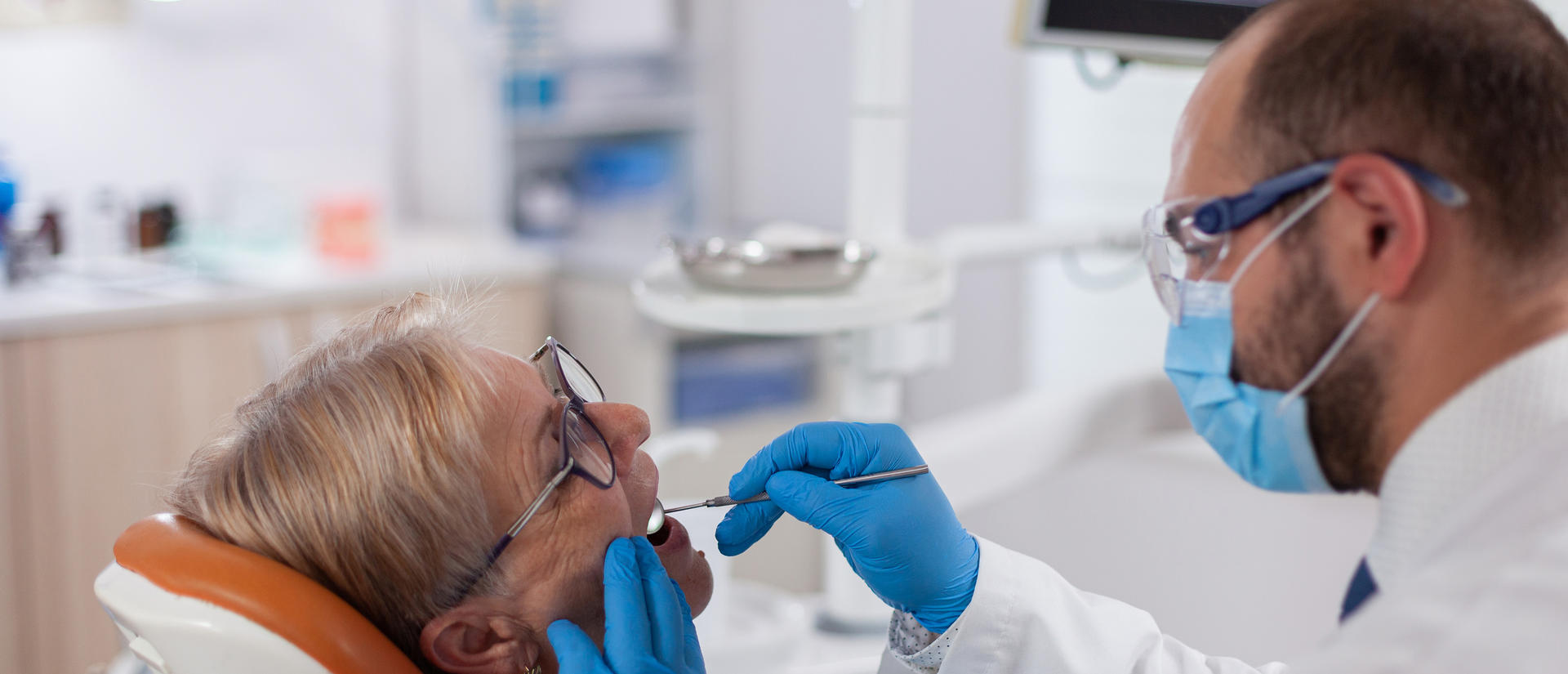 senior having teeth examined 