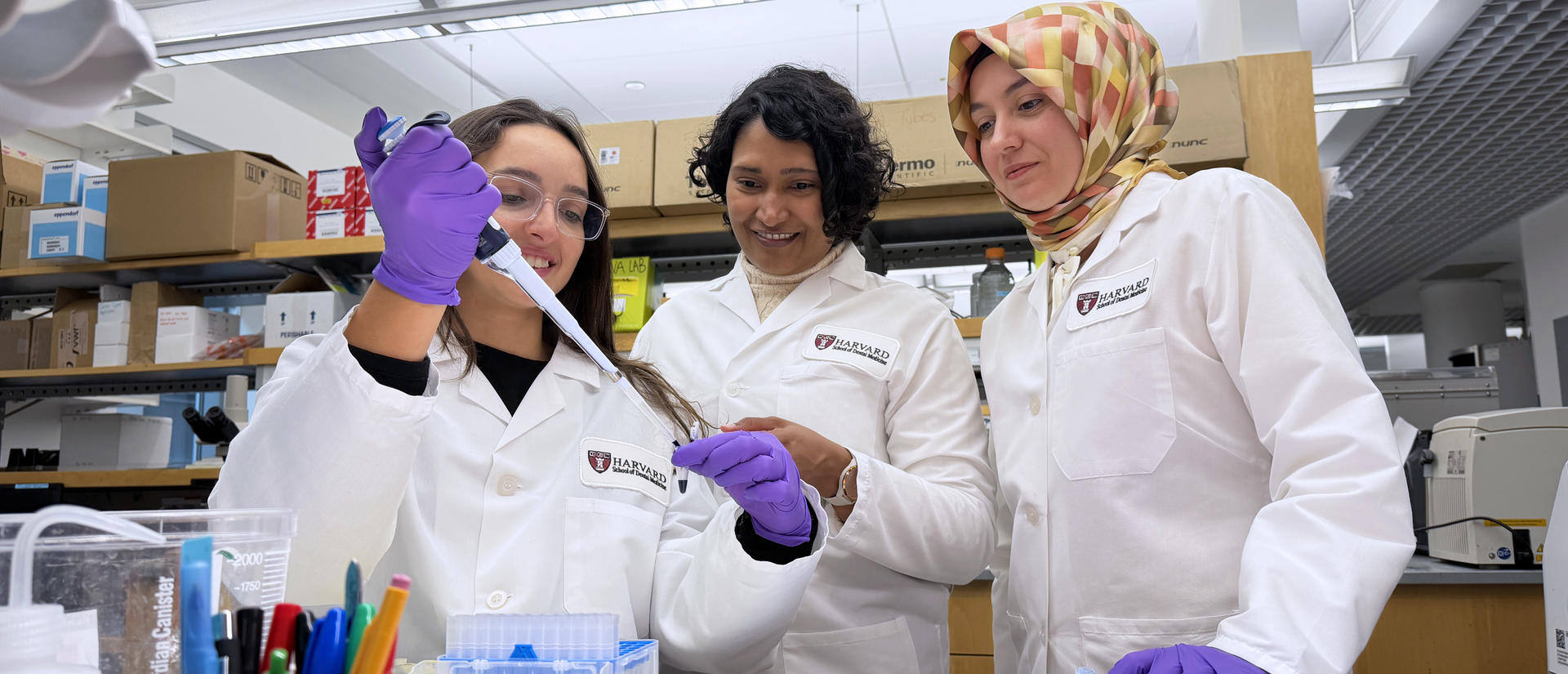 Three people in a wet lab 