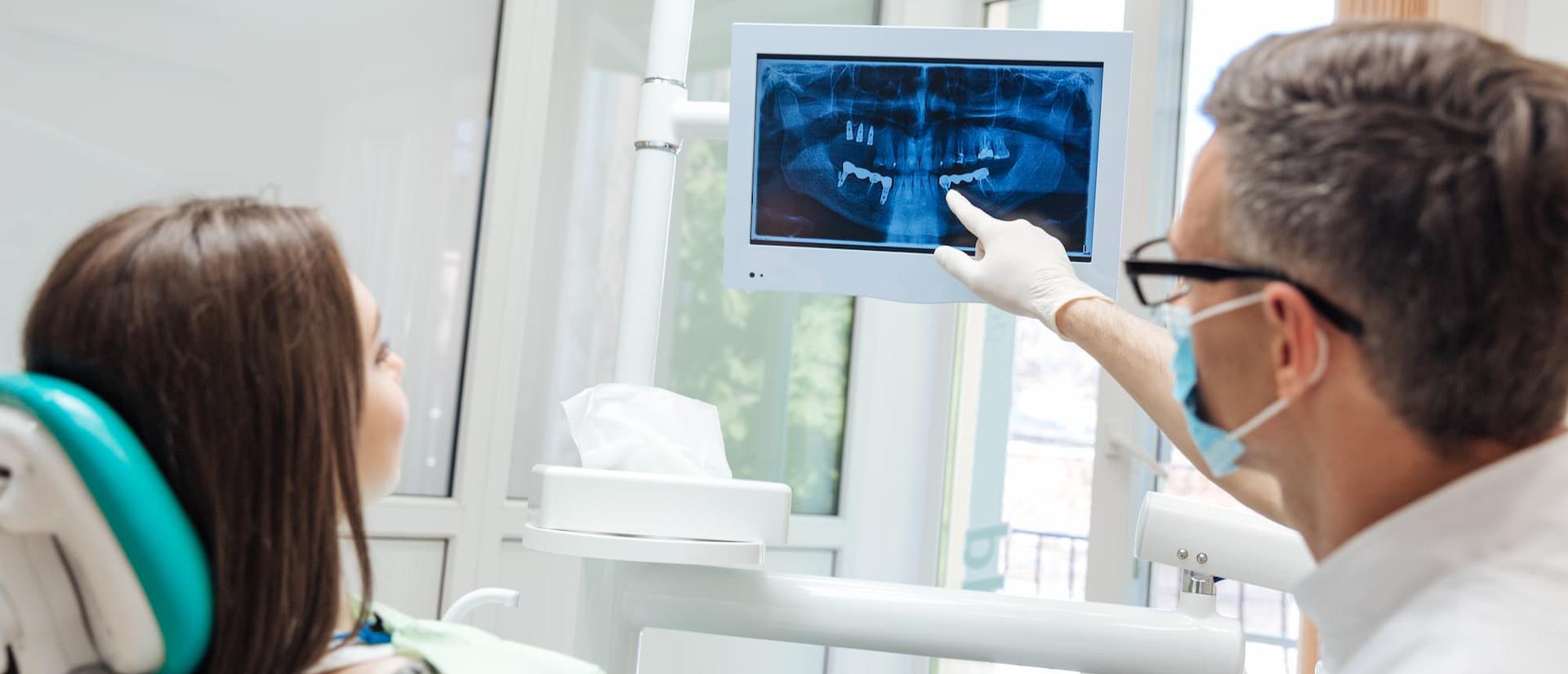 dentist and patient reviewing an x-ray