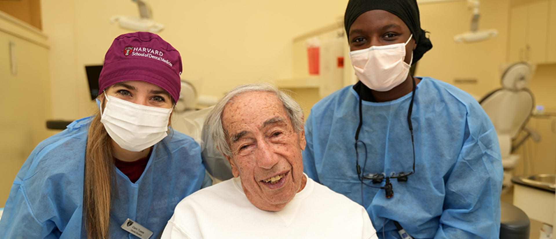 student dentists with elderly veteran