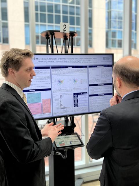 Student in front of screen taking with a judge