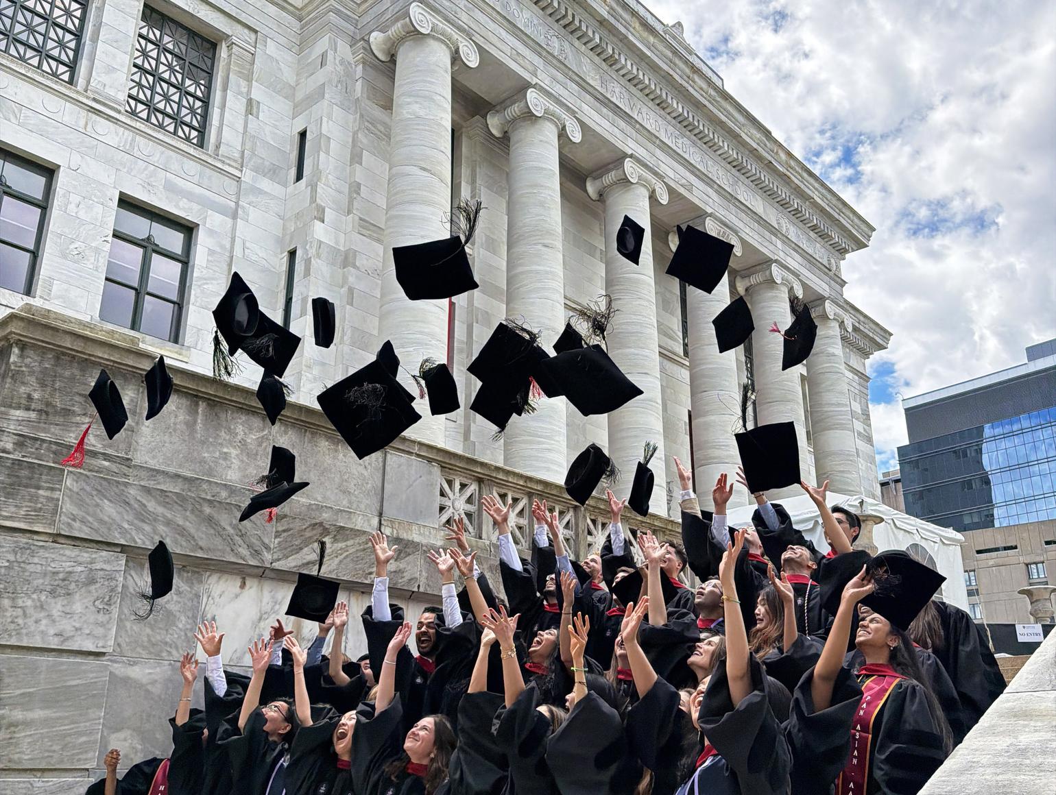 graduates throw caps in the air 