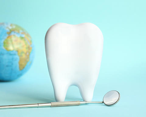 tooth with a globe in background