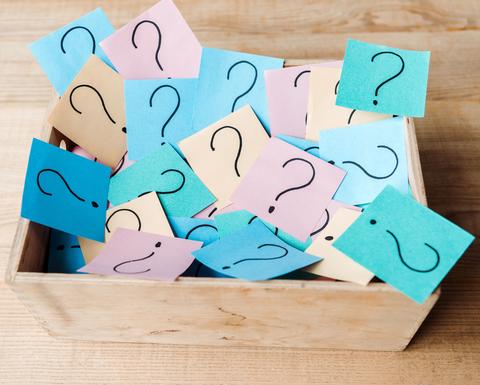 Sticky notes with question marks written on them in a box