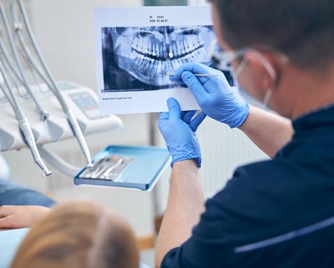Surgeon with female discussing her jaw x-ray