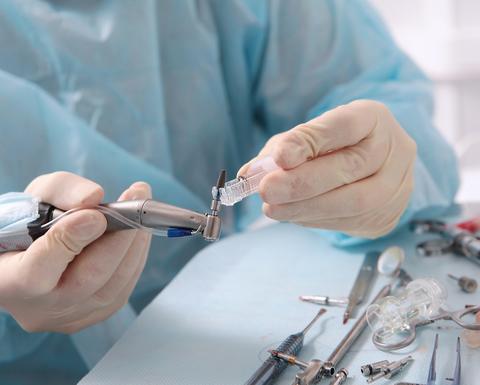 Dental implant in the hands of a surgeon. 
