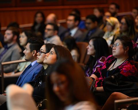 audience in a darkened auditorium